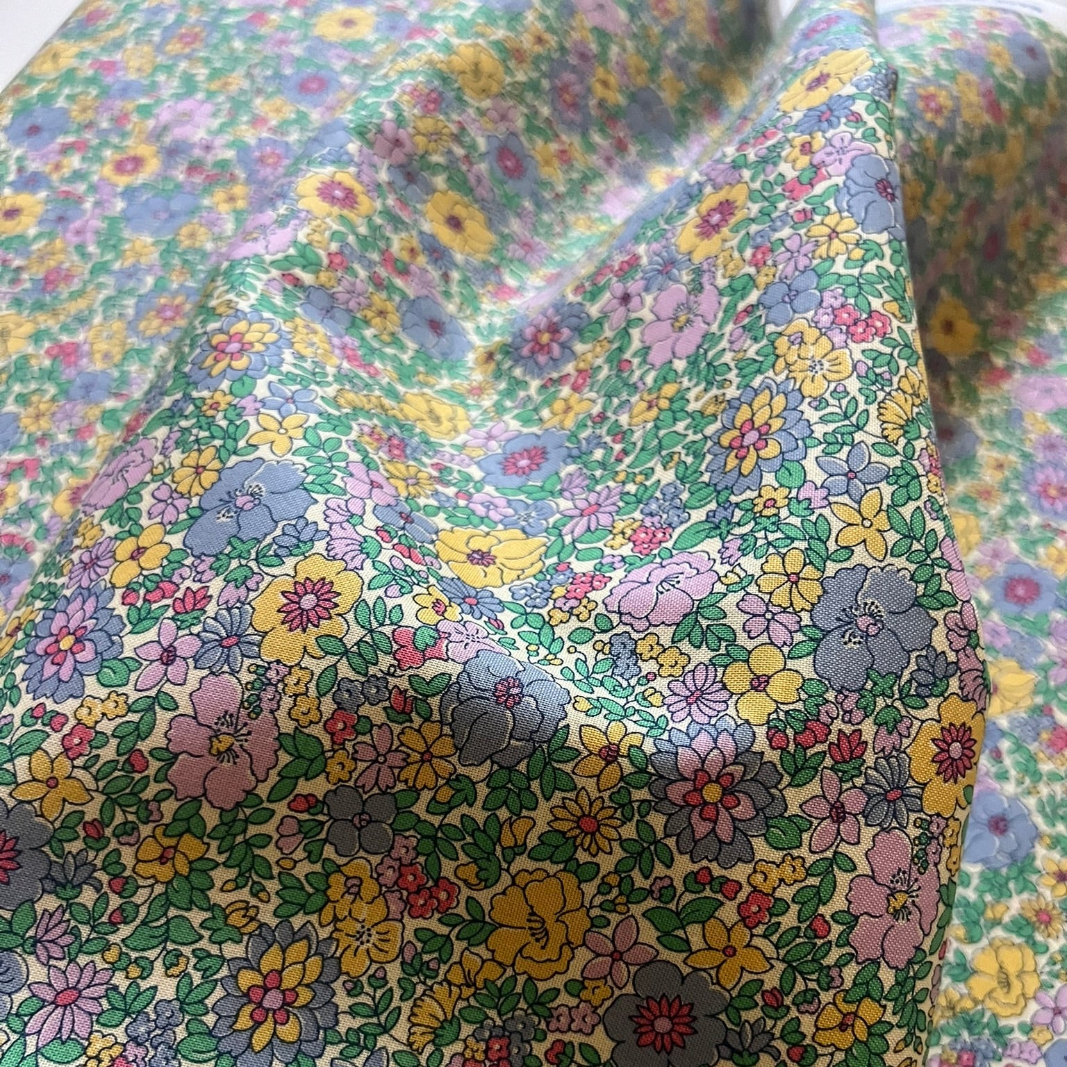 Close-up of a floral patterned fabric with multicolored flowers.